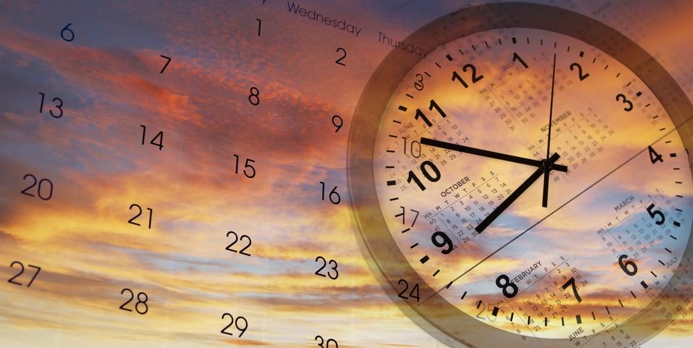 A clock face layered over a wall calendar against an orange and blue evening sky
